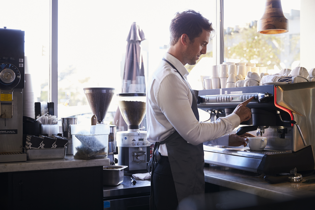 barista making coffee at machine