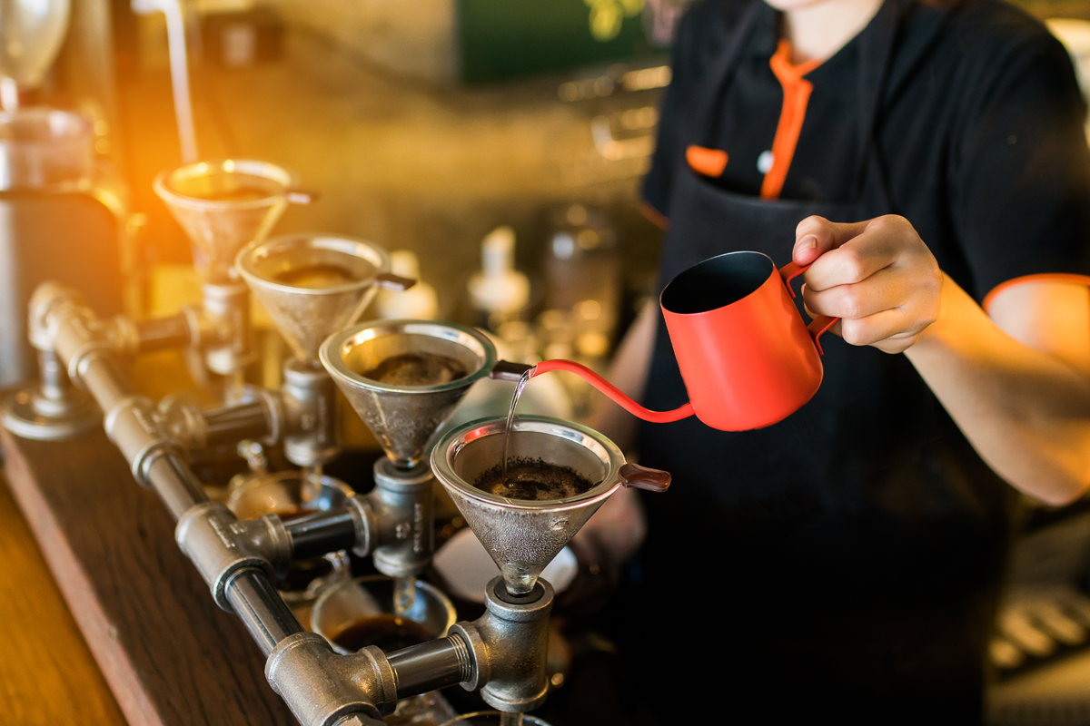 barista making a pour over coffee